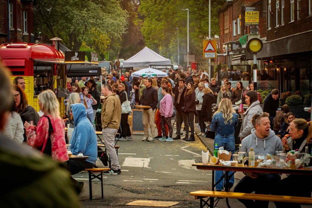 Crowds enjoying a vibrant outdoor street food market organised by The Market Co. in Wilmslow, Cheshire, featuring independent food vendors.