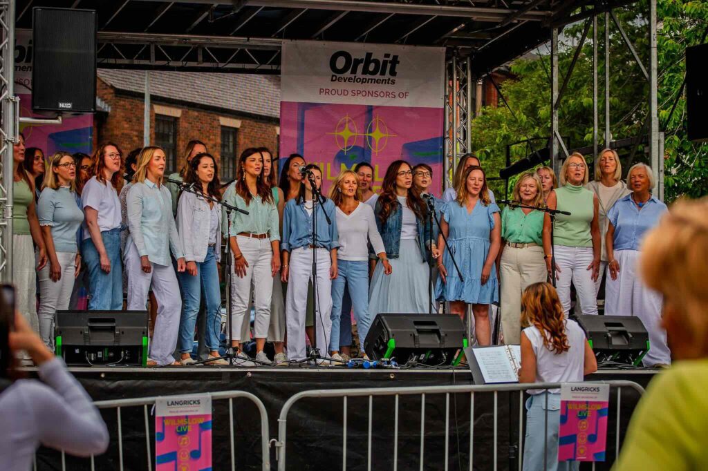 Crowds enjoying live street music and street food organised by Wilmslow BID, Cheshire.